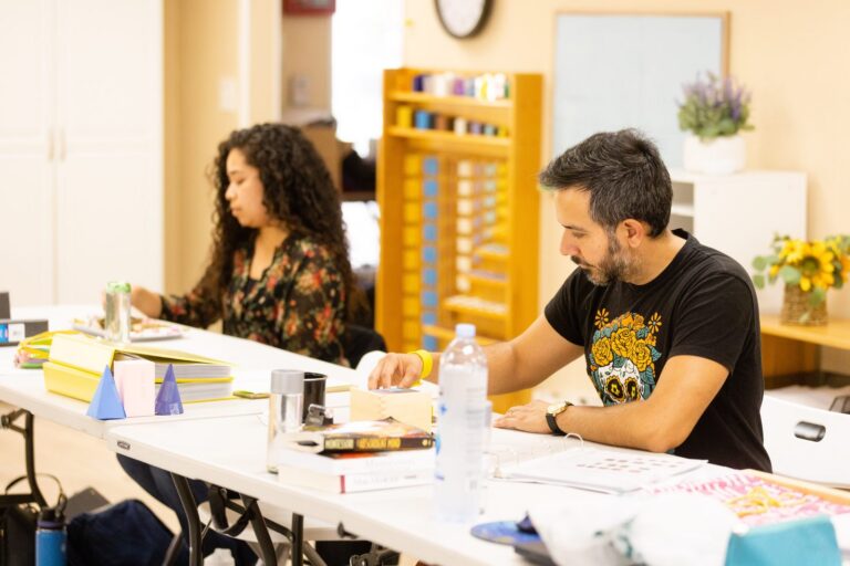 Adult learners studying Montessori geometric solids during teacher training