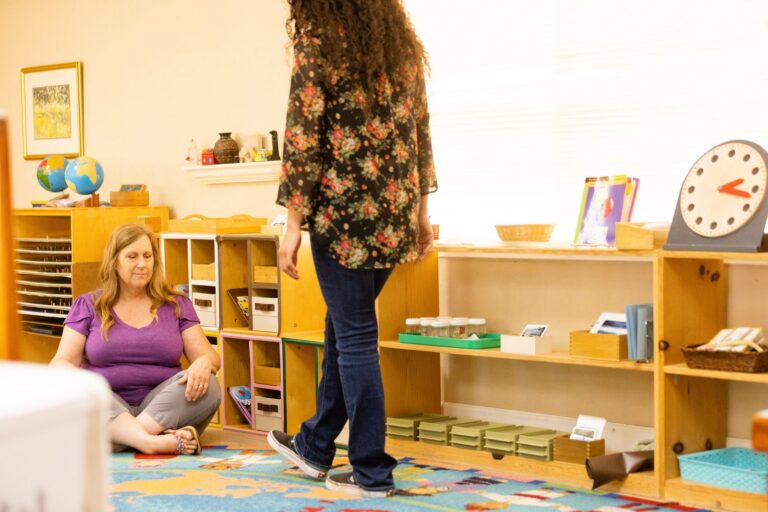 Program Director Karin Osterberg observing an adult learner practice in a prepared Montessori classroom at MCTE